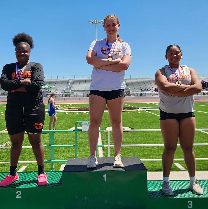 Left to Right: Serenity Smith (district runner-up), Macy Sample (district champion) and Malory Clack (third place) on the podium at the district meet in Cuero with their medals in the discus event; all three cliched a spot in the area meet at Canyon Lake High School Wednesday, April 10.