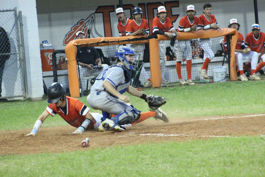 Gonzales senior Weston Ruddock (2) slides on home plate from a RBI single by Brandon DuBose against La Vernia.
