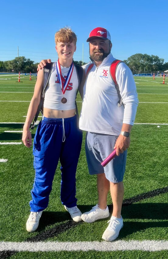 Senior Luke Moses with head track coach Troy Moses at the area track meet in Altair Texas Tuesday, April 11. Moses clinched a spot in the regional meet in Seguin for the 110 meter hurdles