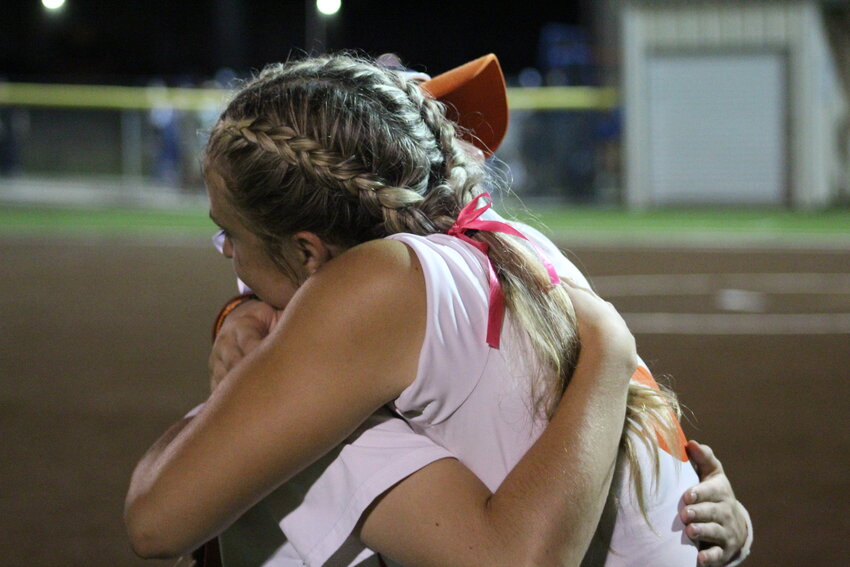 Lady Apaches seniors Sydney McCray (3) and Dakota Schmidt (15) hug each other in their final game as members of the Gonzales High School softball program. The Lady Apaches ended their season as area finalist in their, 2-0, loss to Needville.
