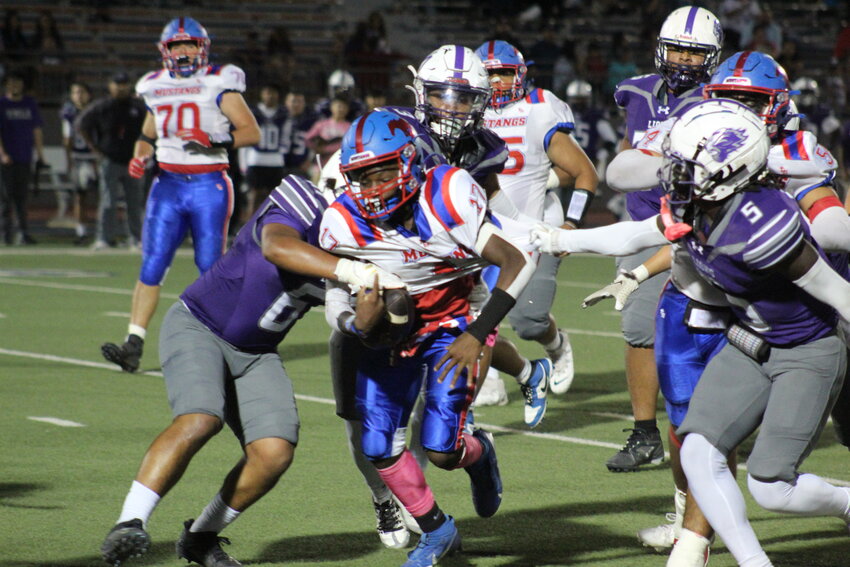 Mustangs freshman running back Joe White (17) runs through Lions defenders at Alamo Stadium on Friday, Oct. 18.