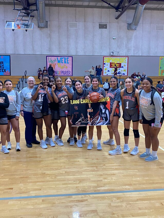 Gonzales senior Bella Aguero (2) celebrates with her teammates after becoming the first Lady Apaches basketball player to reach 1,000 points in the Hallettsville game Tuesday, Nov. 12.