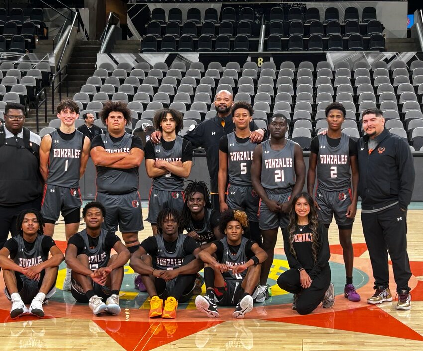 The Gonzales Apaches players and coaching staff stand in the middle of the court of the Frost Bank Center (home of the San Antonio Spurs) Wednesday, Nov. 26.