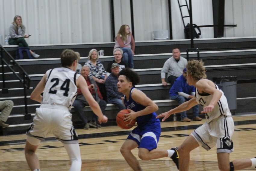 Mustangs freshman guard Henry Benavides (4) moves the ball pass two Moulton players in the Moulton Tournament Thursday, Dec. 12.
