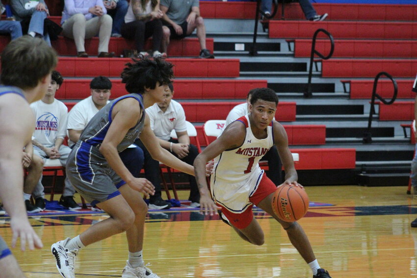 Mustangs senior guard Zechariah Munoz (12) defends a La Vernia player in the non-district contest.