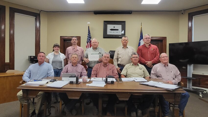 Seated from left: County Judge Pat Davis, County Commissioners Collie Boatright, Donnie Brzozowski, Roy Staton and Tony Matias.  Standing from left: NRCS Conservationists Sarah Godwin and James Davis, Gonzales County SWCD Chairman Phil Breitschopf, Secretary/Treasurer Lance Benes, and Board Member Mike Kuck.
