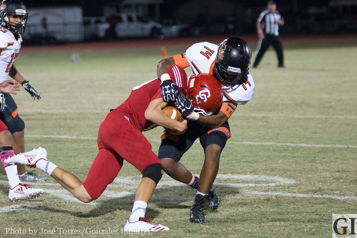 Kenneth Cavit (14) wraps up a rusher.