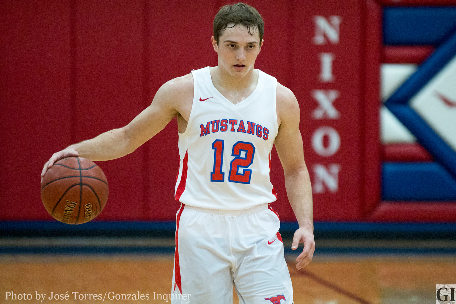 Colby Newman (12) dribbles out past half court. He came away with 12 points in the Mustangs’ 55-46 loss.