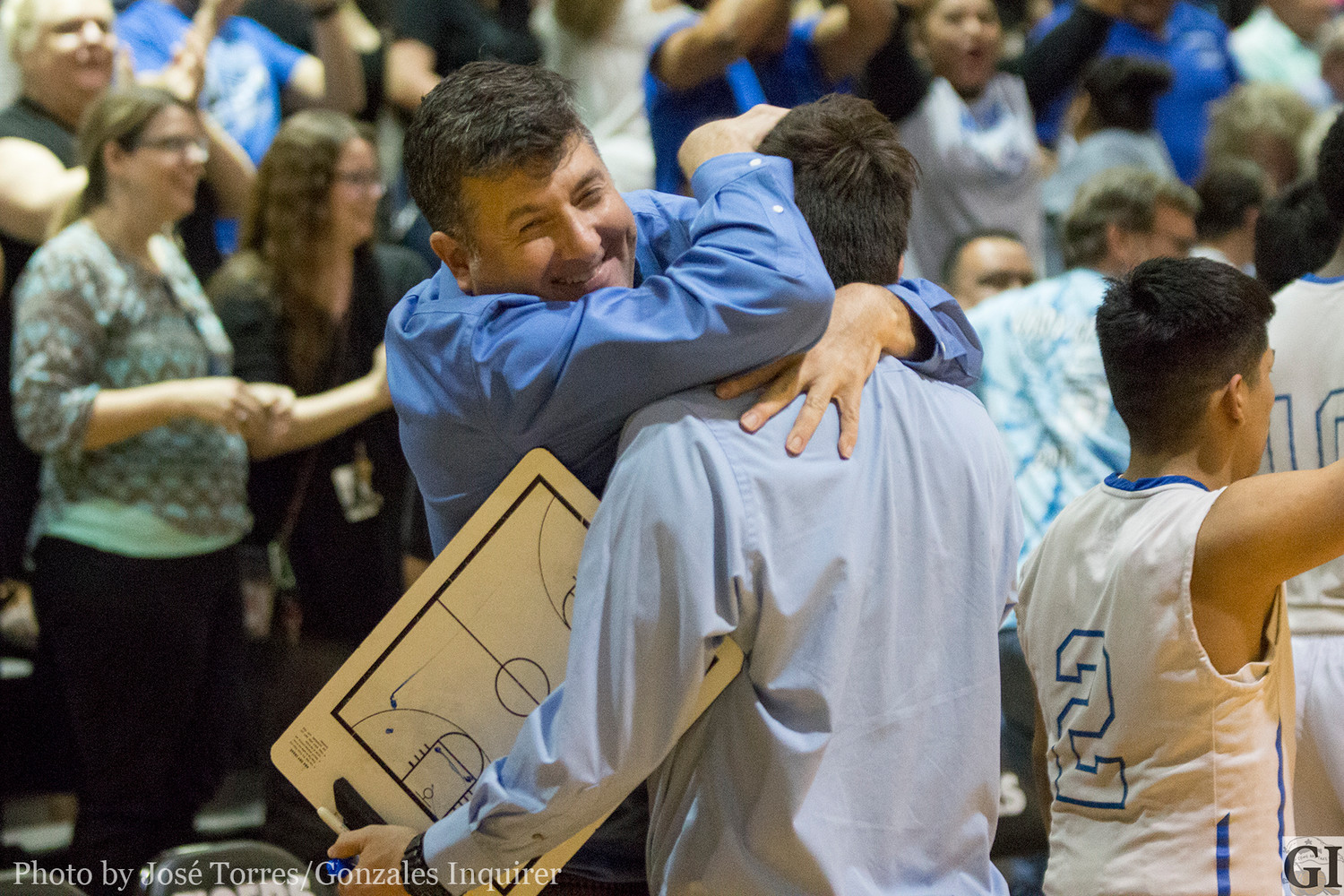 Waelder Superintendent Jon Orozco embraces Head Coach Jacob Garcia after the four-point win Tuesday night.