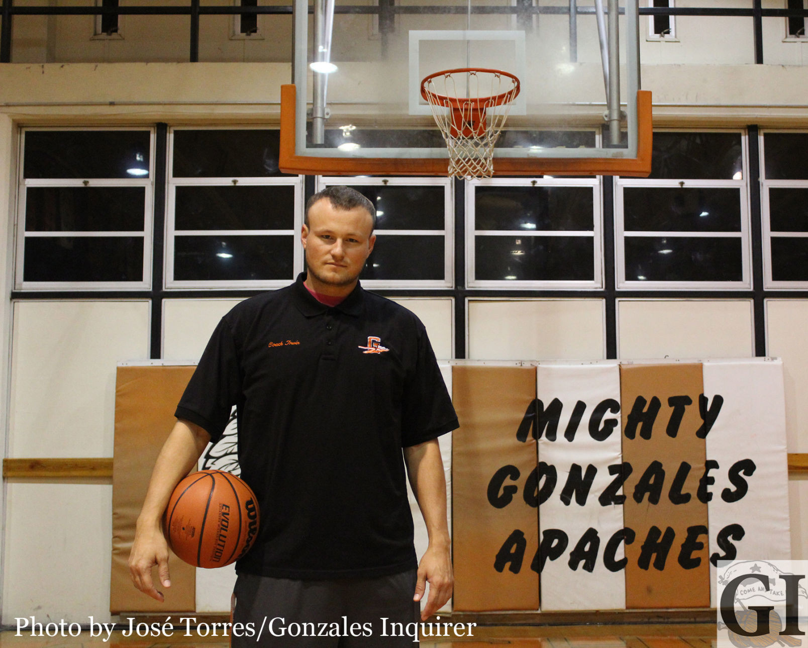 New head coach A.J. Irwin poses in the “old” gym at Gonzales High. Irwin wants to take it back to his playing days and rebuild the “Runnin’ Apaches” with his current crop of athletes. 