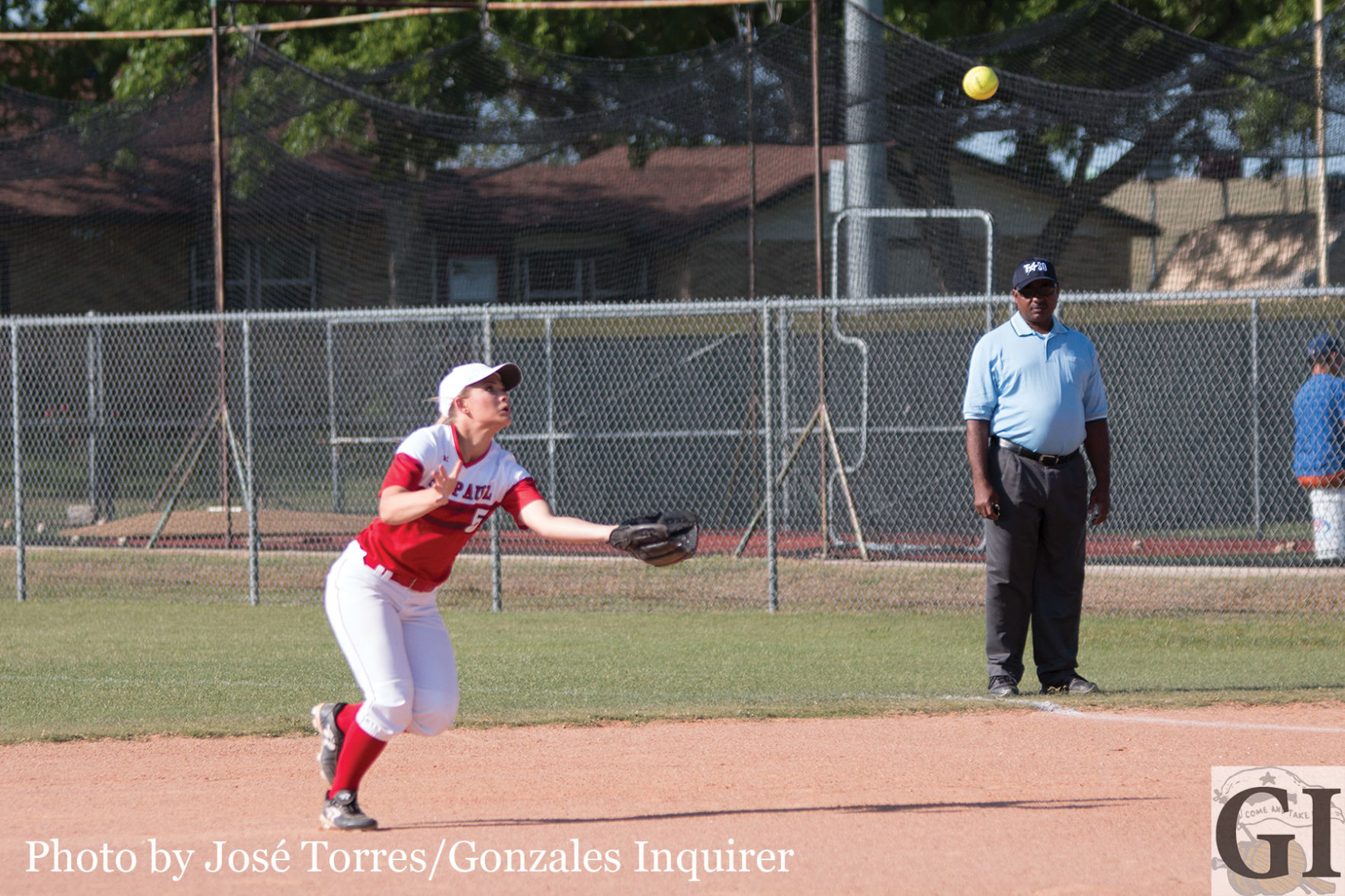 Anna Adamek (5) makes a diving catch in between first and second base.  