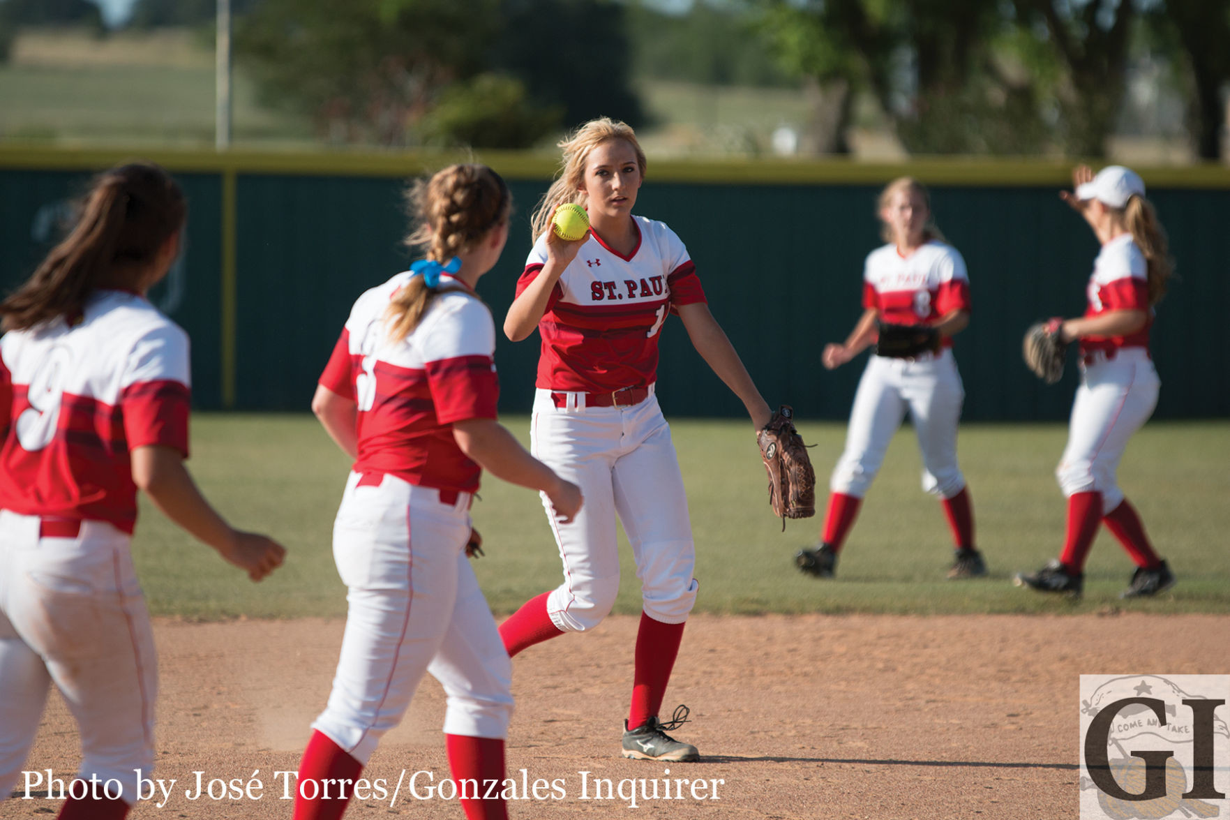 Delynn Pesek (15) shows off the ball after tagging out a runner in the second.