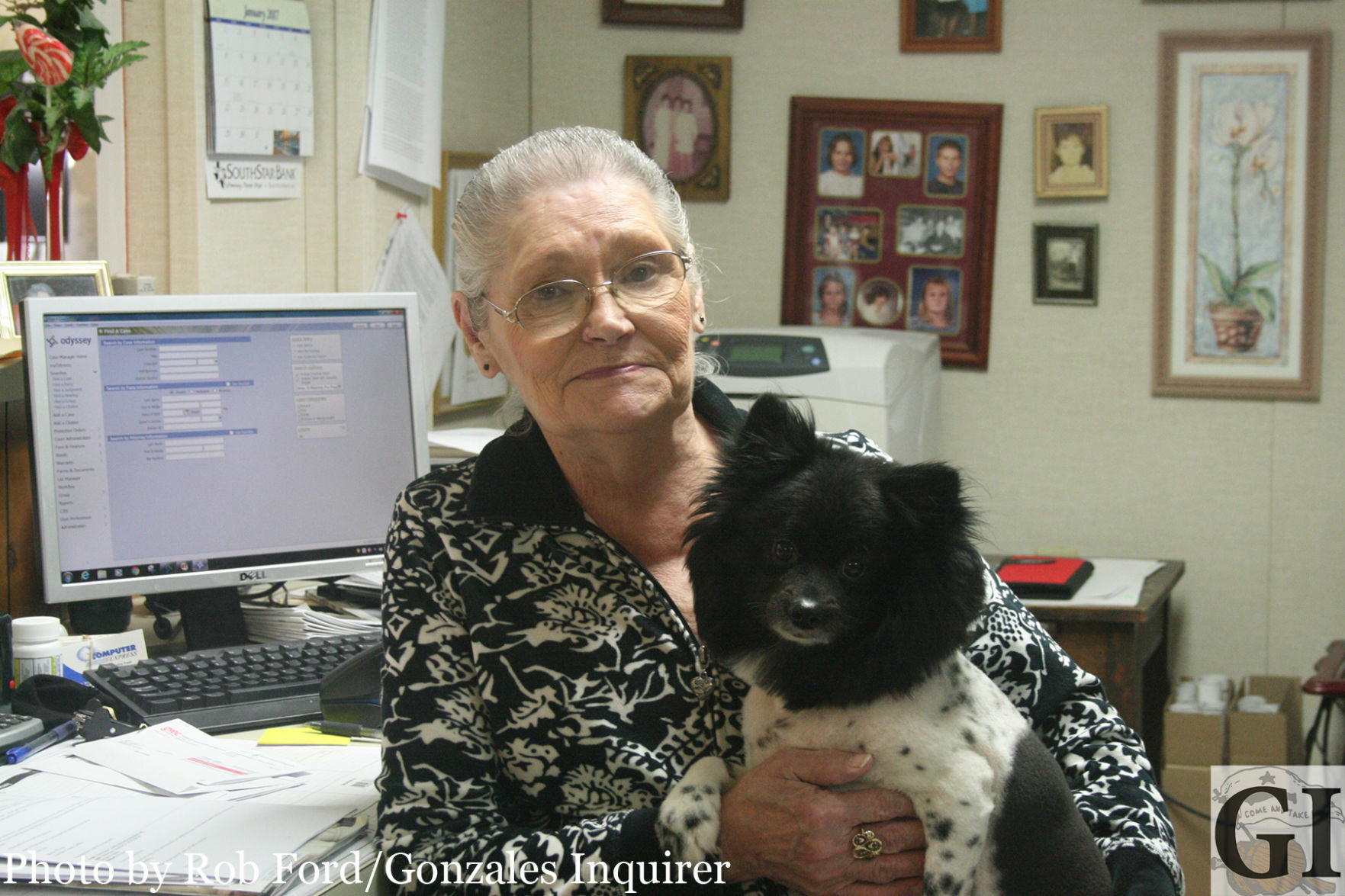 County Clerk Lee Riedel with her dog Pee-Wee at the county annex building. Riedel is retiring after nearly 20 years working for Gonzales County.