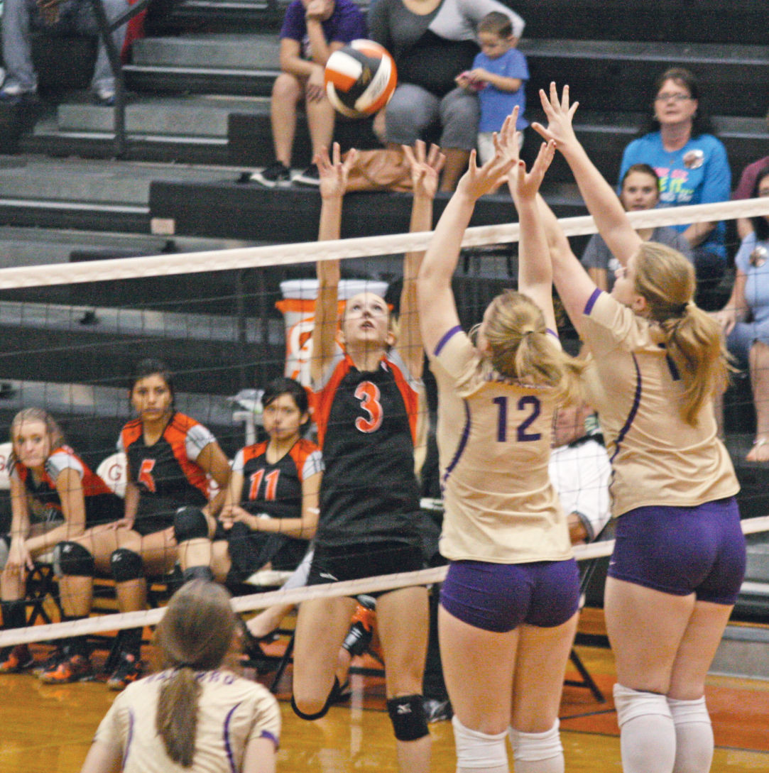 #3 Alex Finch tries to tip it over Navarro Lady Panther blockers during Tuesday’s match at home.