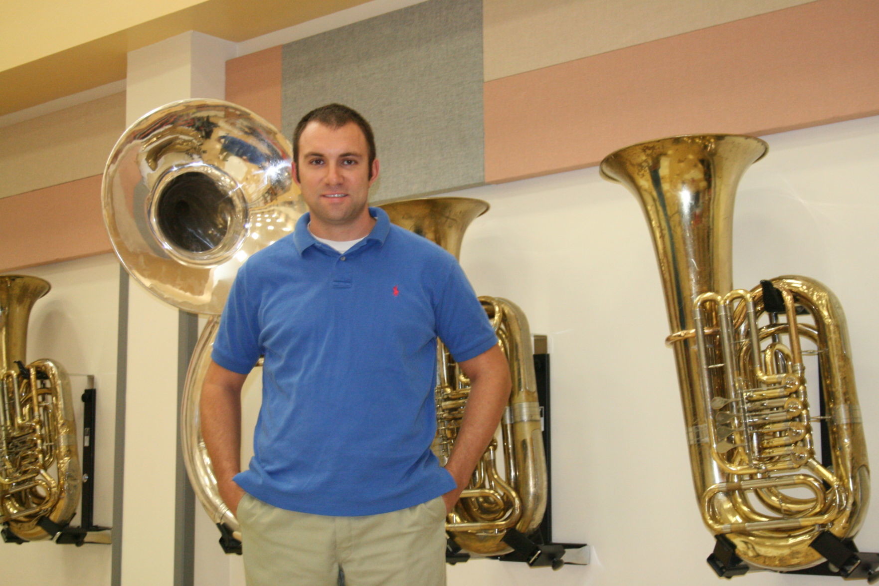 GHS band director Raymond Parker poses amid a brassy backdrop of valves and bells. Although he dreams of one day taking the Apache Band back to state finals, he says it’s no big rush - and he and his young musicians are going to live the dream one marching step at a time.