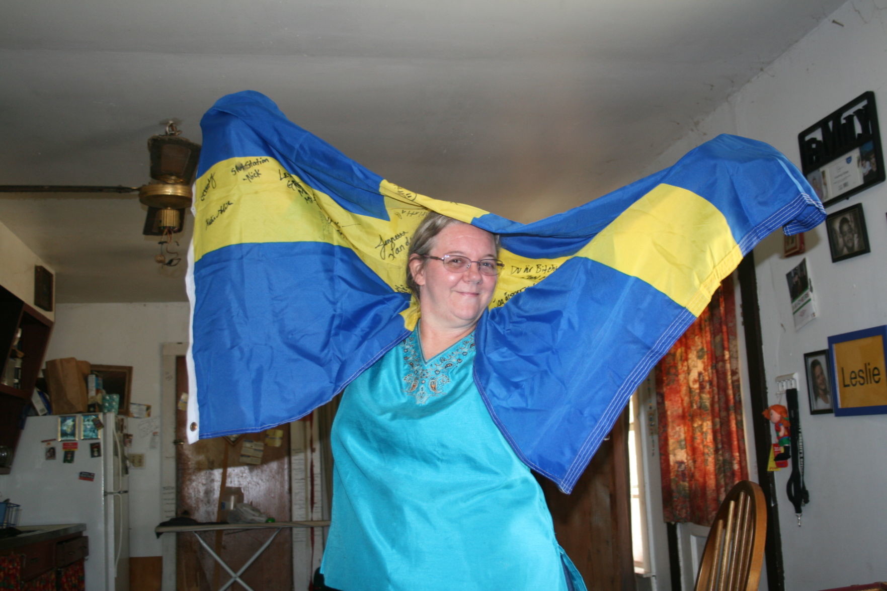 Adorned in a Swedish flag replete with signatures of friends and family from a distant land, Leslie Longoria basks in the banner of the home of her ancestors.