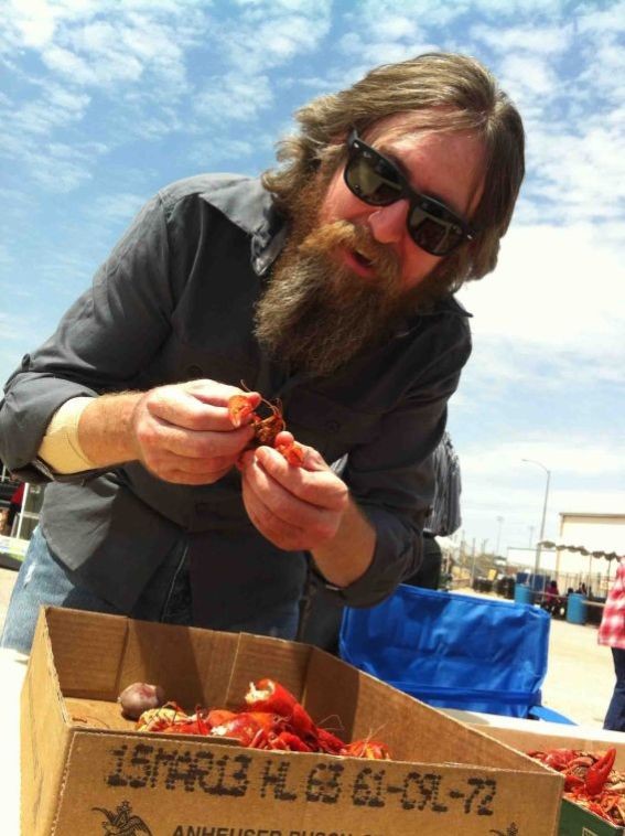 Jeremy Halliburton enjoys a flat of crawfish while his band takes a break at a recent crawfish festival.
