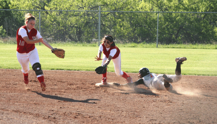 Nixon-Smiley shortstop Jordan Newman (left) intercepts a throw to second base Thursday, as second baseman Miranda Carrilo stands ready to field the ball while fending off a sliding Karnes City runner. The Lady Mustangs finished on the short end of a 14-3 score.