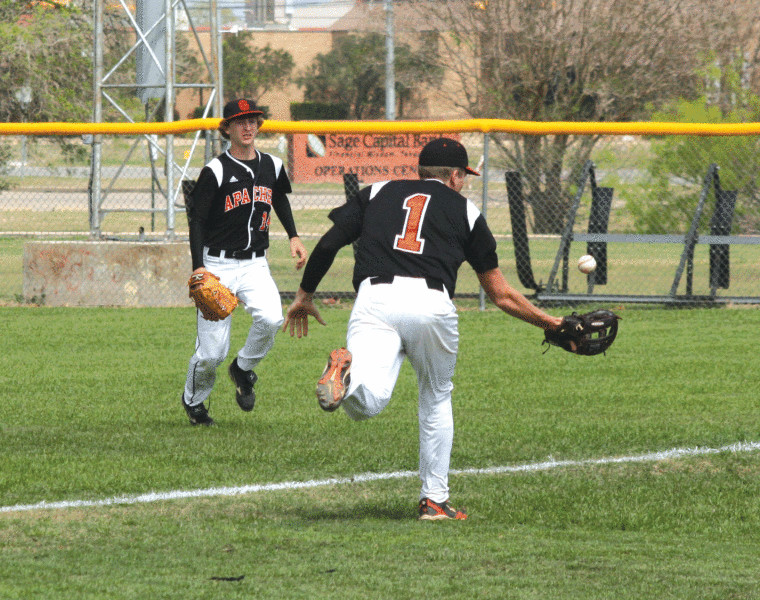 Trey Kridler (1) of Gonzales reaches out to snag a popup in foul territory Saturday as rightfielder Brant Philippus (14) converges to help. Kridler made the catch for the out, but the Apaches dropped an 11-3 decision to Giddings.