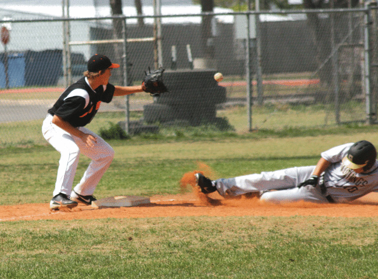 Brant Philippus of Gonzales awaits the ball thrown from left field as a Giddings player slides into third base Saturday. The tag on the play was late, and the Apaches were on the short end of an 11-3 verdict.