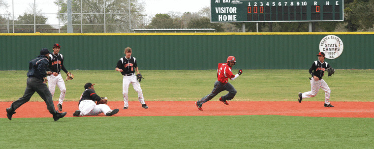 Four Gonzales players converge on a fleeing Brazos base runner during a rundown between second and third base Friday at the Jimmy Appelt Tournament in Hallettsville. Working together to get the out included (from left) Dylan Gomez, Zach Clack-Perez (on ground with ball), Zachary Akers and Dalton Kuntschik. The base runner was called out when he ran outside of the basepath, but Brazos posted a 3-0 win.