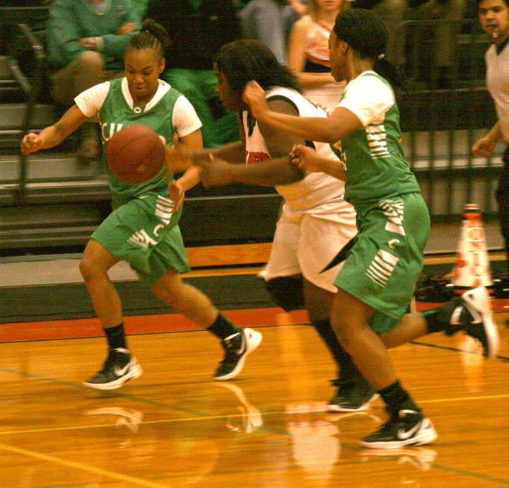 Gonzales Lady Apache forward Jade McCook, center, chases down a loose ball in between a pair of Cuero defenders during the Lady Apaches’ 50-49 win over the Lady Gobblers Tuesday in Gonzales.