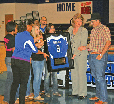 Members of the Waelder basketball and volleyball teams present Courtney Orona’s jersey to her parents, Deanna and Rudy Orona, during a Nov. 2 ceremony retiring Courtney’s jersey.