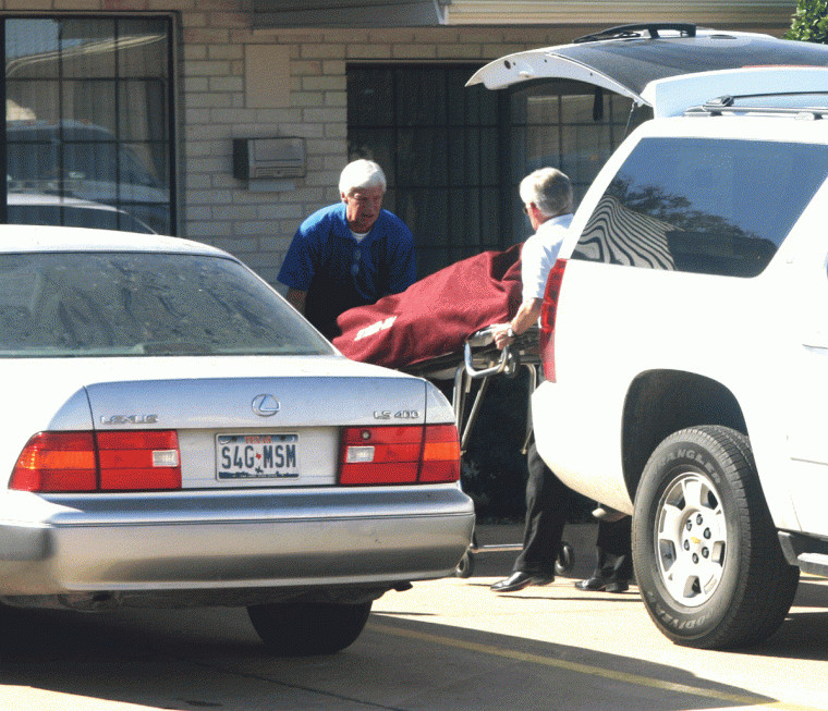 A body discovered Thursday in a guest room at the Best Western Regency Inn & Suites in Gonzales is removed by funeral home personnel. No official cause of death was reported.