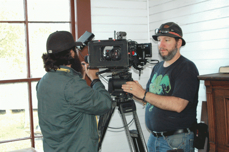 The crew sets up a camera in the church at the Pioneer Village Living History Center in Gonzales, Texas.