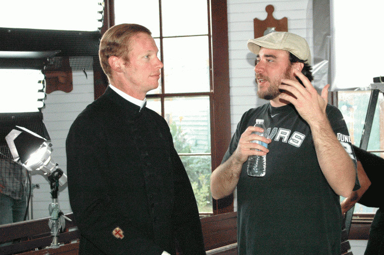 Craig Ries (left) gets some final instructions from co-director Duane Graves for a scene shot in the church at the Pioneer Village Living History Center in Gonzales, Texas.