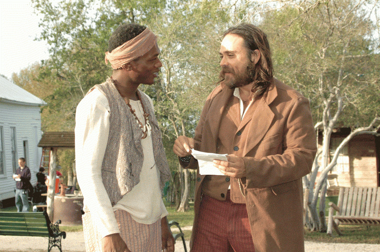 Deon Lucas (left) discusses the script with Justin Meeks while shooting scenes at the Pioneer Village Living History Center in Gonzales, Texas.