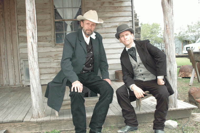 Luce Rains (left, who was the sheriff in "3:10 to Yuma") and Timothy McKinney relax in front of the Gates House at the Pioneer Village Living History Center in Gonzales, Texas. Rains plays Sheriff Everheart and McKinney plays Deputy Marshal Peak in "Red on Yella, Kill a Fella."