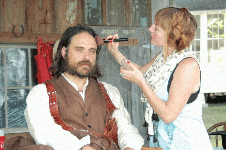 April Swartz (right) applies makeup to Justin Meeks during filming of "Red on Yella, Kill a Fella" at the Pioneer Village Living History Center in Gonzales, Texas.