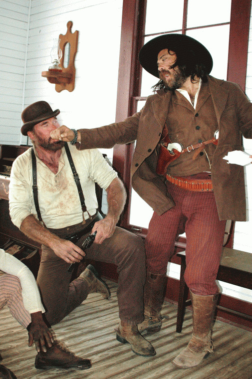 Co-director Justin Meeks (right) shows Greg Kelly how to deliver a glancing blow during an upcoming scene filmed in the church at the Pioneer Village Living History Center in Gonzales, Texas.
