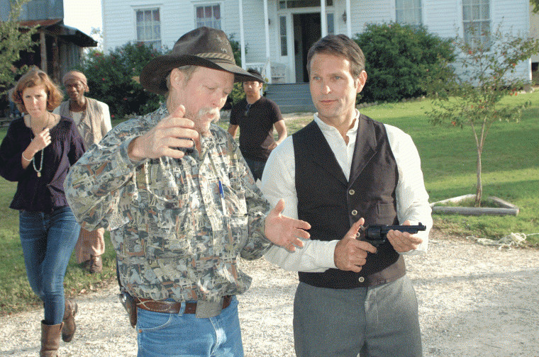 Doyle Culpepper (left) explains to Tom Lagleder the amount of room to expect when his pistol is fired during a shootout at the Pioneer Village Living History Center in Gonzales, Texas.