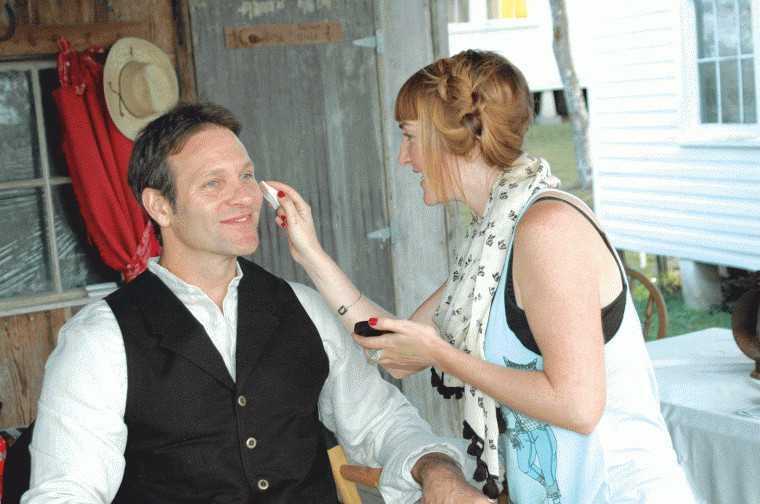 April Swartz (right) applies makeup to Tom Lagleder on the set of "Red on Yella, Kill a Fella." Several scenes were filmed at the Pioneer Village Living History Center in Gonzales, Texas.