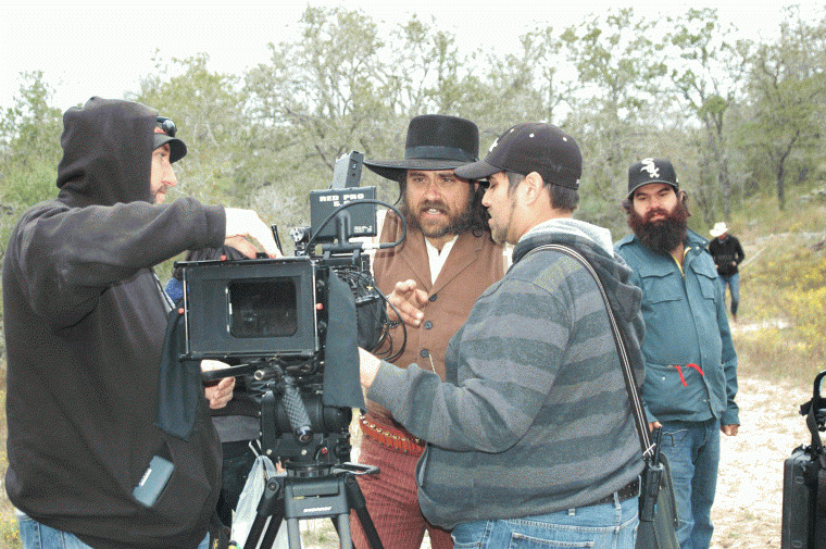 Co-director Justin Meeks reviews a scene with his camera crew during the filming of "Red on Yella, Kill a Fella," part of which was shot at the Meeks Ranch northeast of Gonzales, Texas.