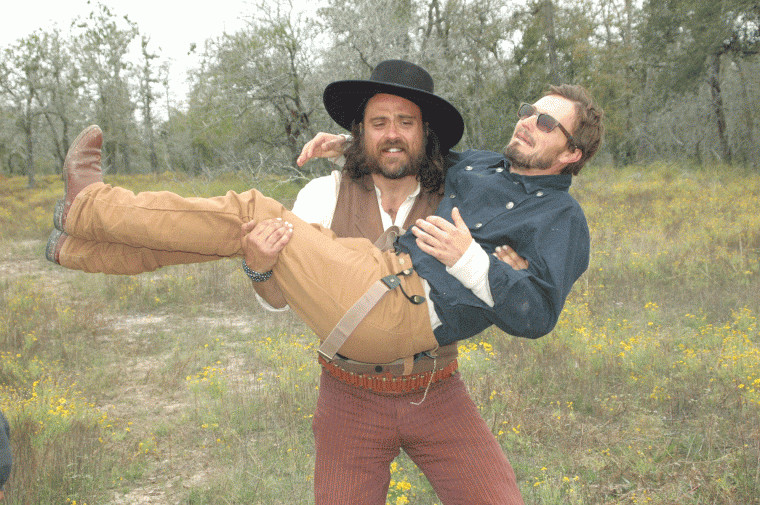 Justin Meeks clowns with Paul McCarthy-Boyington during filming of "Red on Yella, Kill a Fella" while shooting on location at the Meeks Ranch northeast of Gonzales, Texas.