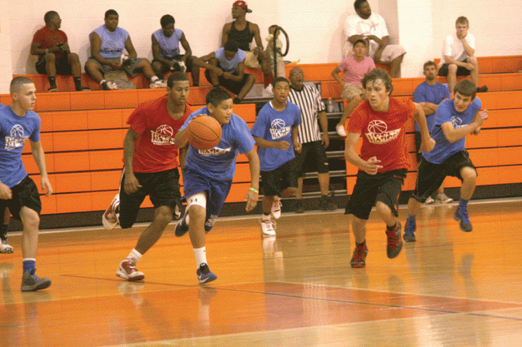 Waelder guard Caleb Ibarra (with ball) dribbles downcourt during a recent game in the Schulenburg Summer Basketball League. Ibarra and the Wildcats were 1-3 going into Monday night’s action.