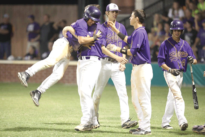 Tyler Patek, far left, is lifted in the air by Ky Sandelovic after scoring the go-ahead run in the Shiner baseball team’s 8-7 win over Thrall Friday in La Grange. Also joining in the celebration are Mat Pohler, center, Brady Cejka, second from right, and Blake Michalec, far right.