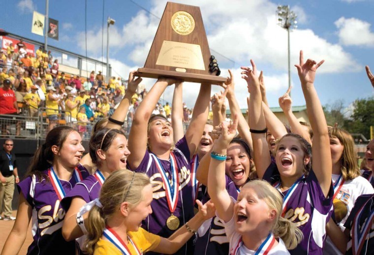 Members of the Shiner Lady Comanches celebrate at McCombs Field in Austin Saturday after the team defeated Grapeland 1-0 to earn the Class 1A state softball championship.