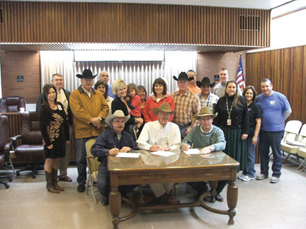 Gonzales City Manager David Huseman (center) and Cowboy Rodeo Productions producers Mark Swearingen (left) and J.C. Kitaif signed a ten-year contract for the annual Cowboy Spring Break Youth Challenge to be held at JB Wells Arena annually in March on Tuesday.