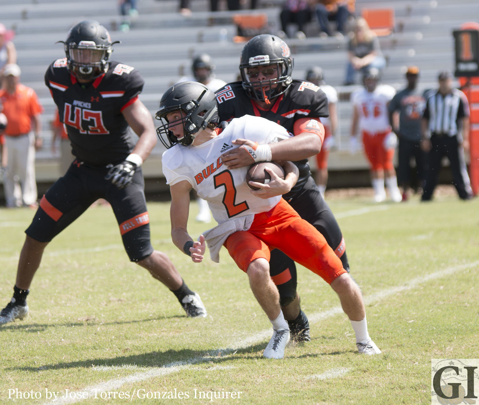 Juan “Bull” Licea (72) wraps up Bulldogs’ quarterback Coleman King (2) as the Apaches’ front pressured him throughout the day. Gonzales would win 21-10.