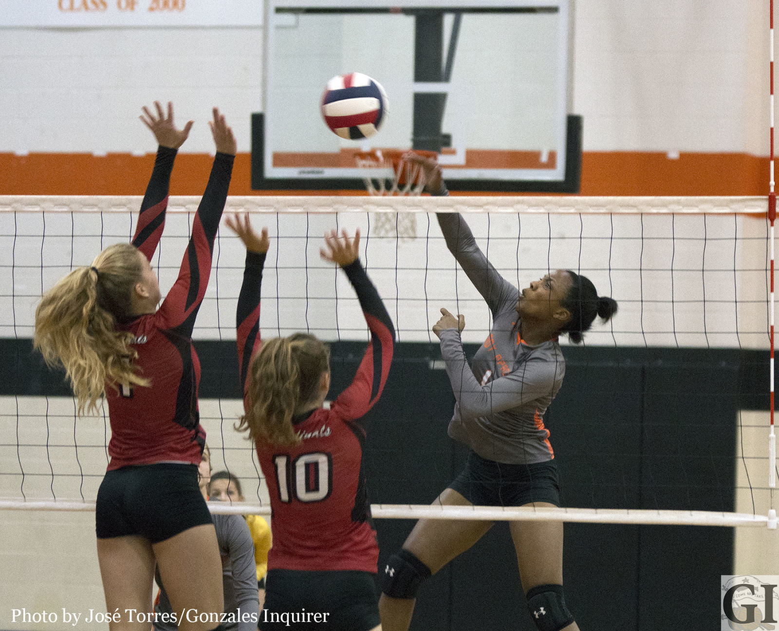 Chelsie Hastings goes up for a swing as Grace Irvin (1) and Riley Johnson (10) attempt a block in Shiner St. Paul’s three-set win over Gonzales.