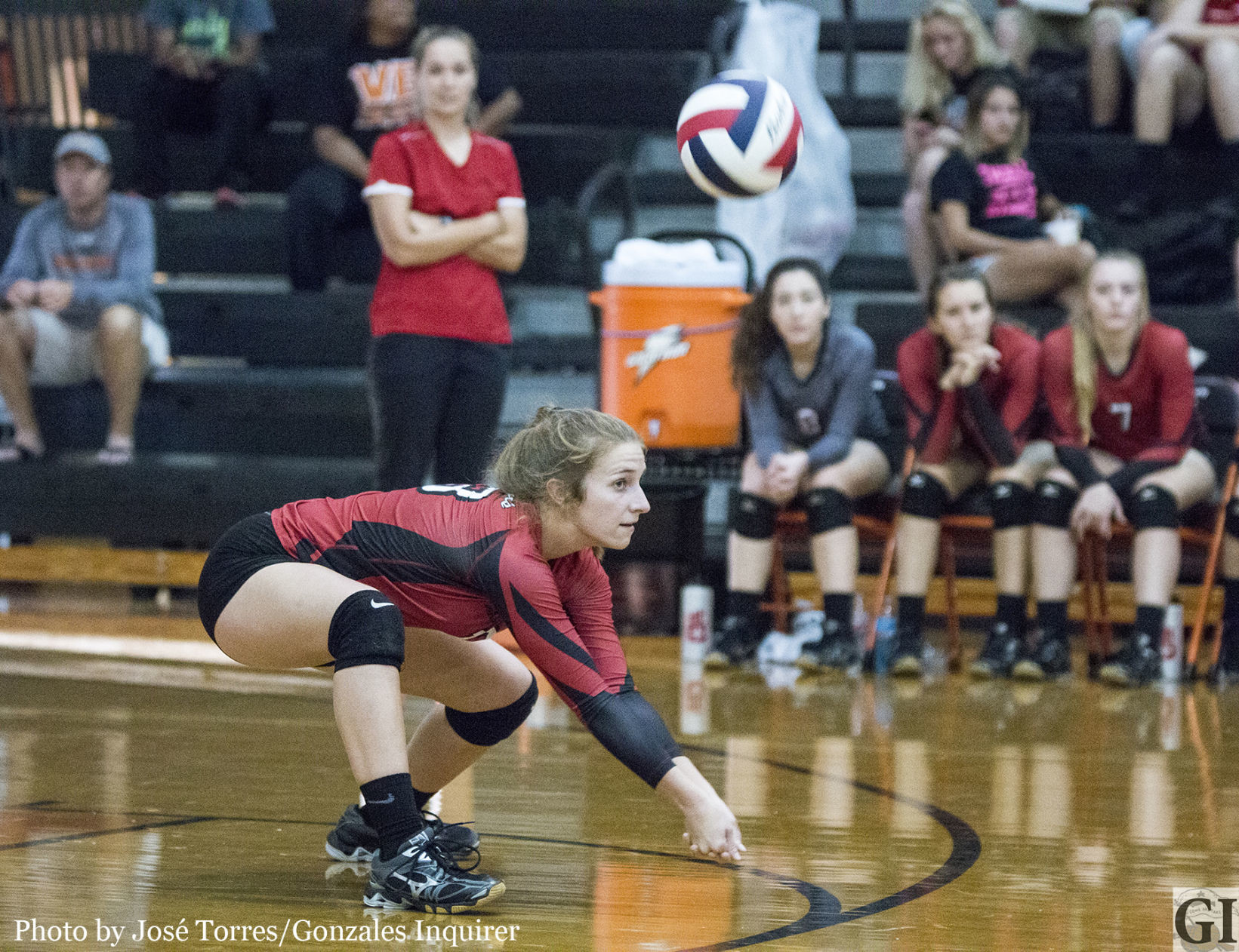 Gracey Novosad (13) gets low to receive a serve in Shiner St. Paul’s three-set win over Gonzales.