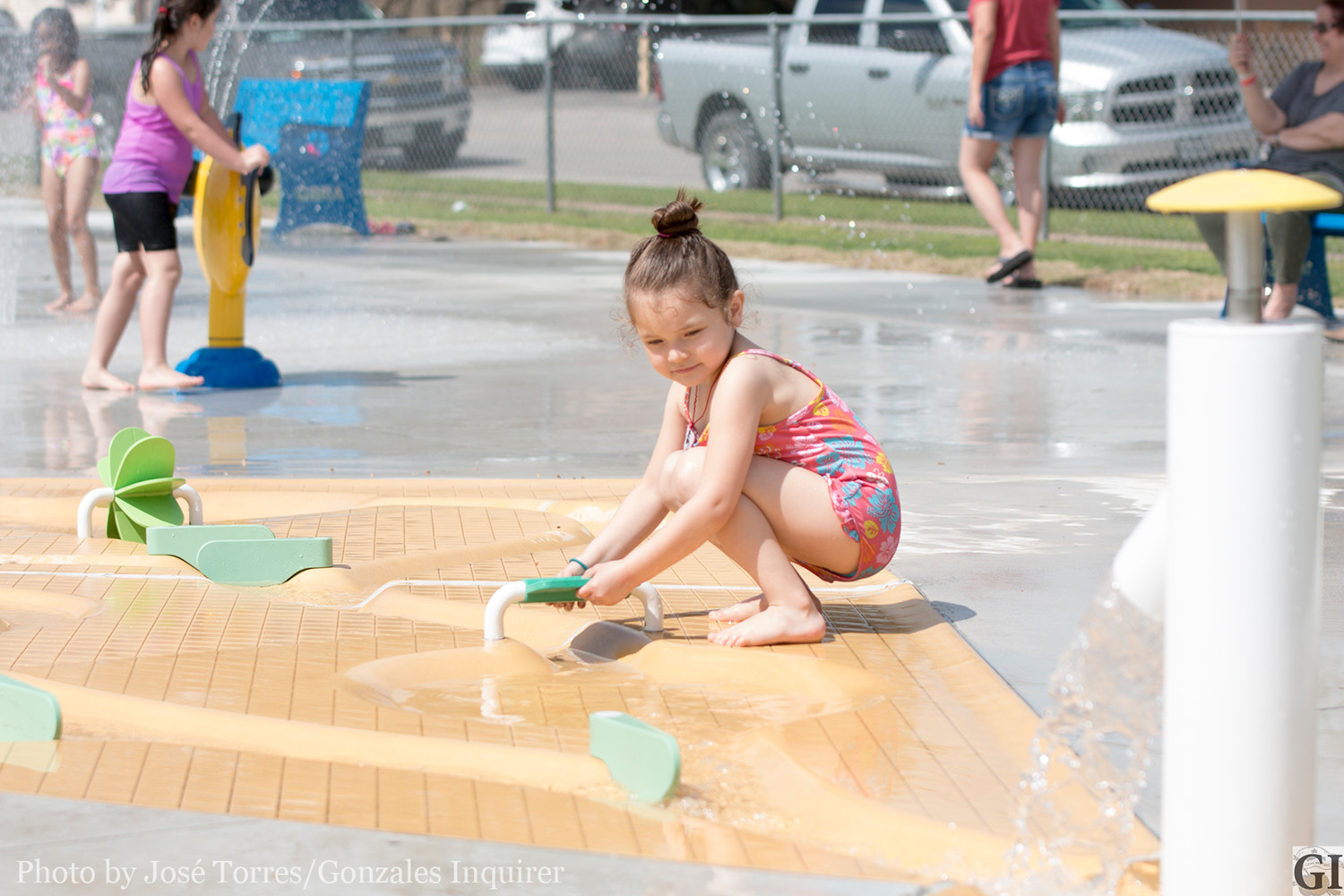 This curious splash pad toddler walks toward the “Water Journey” piece where users can manipulate water to show the life-like stream behavior.