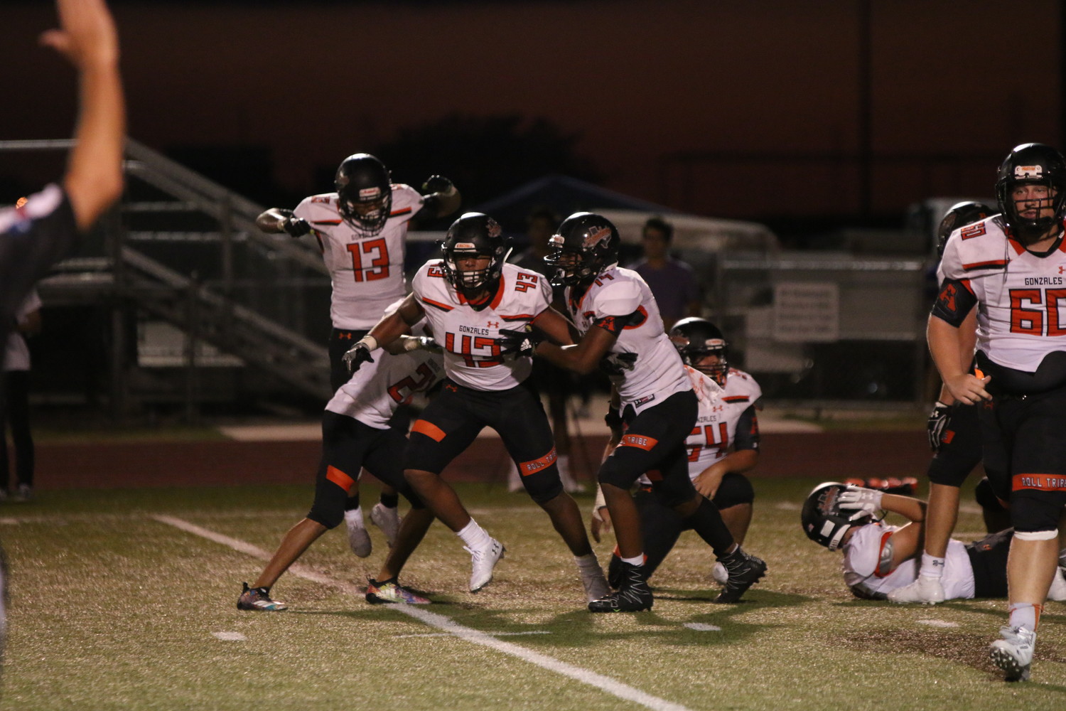 The Apaches defense celebrates a big play on the field.