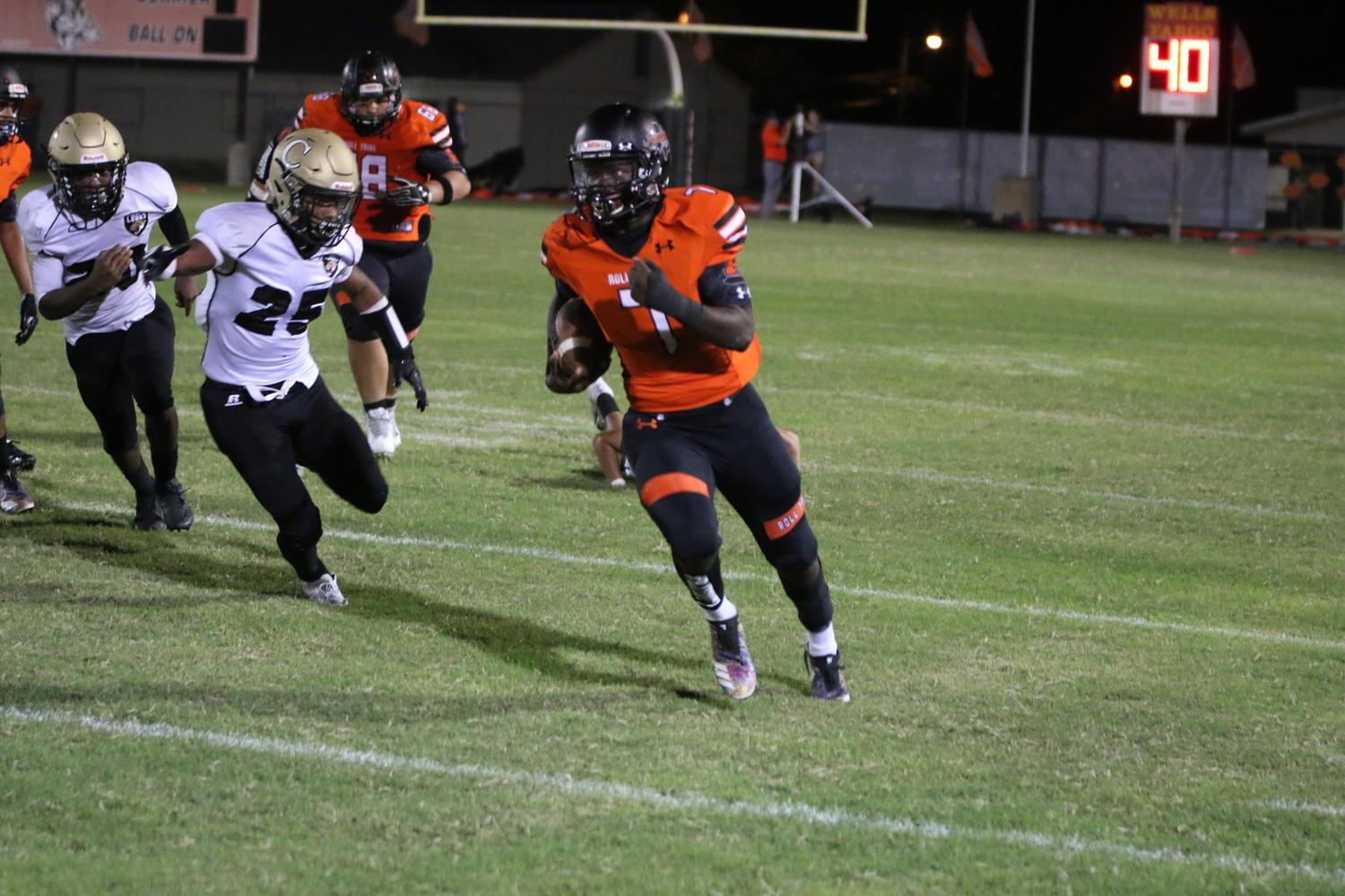 Elijah Holiday (7) busts out a 59 yard touchdown run in Gonzales' 35-0 lead at the half over Austin Crockett.
