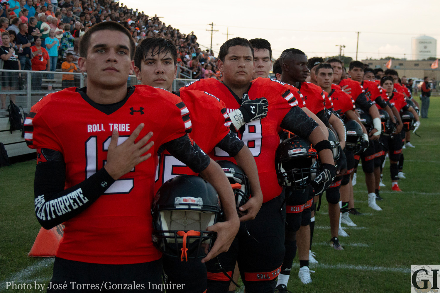 The Gonzales Apaches line up during the pre-game national anthem.