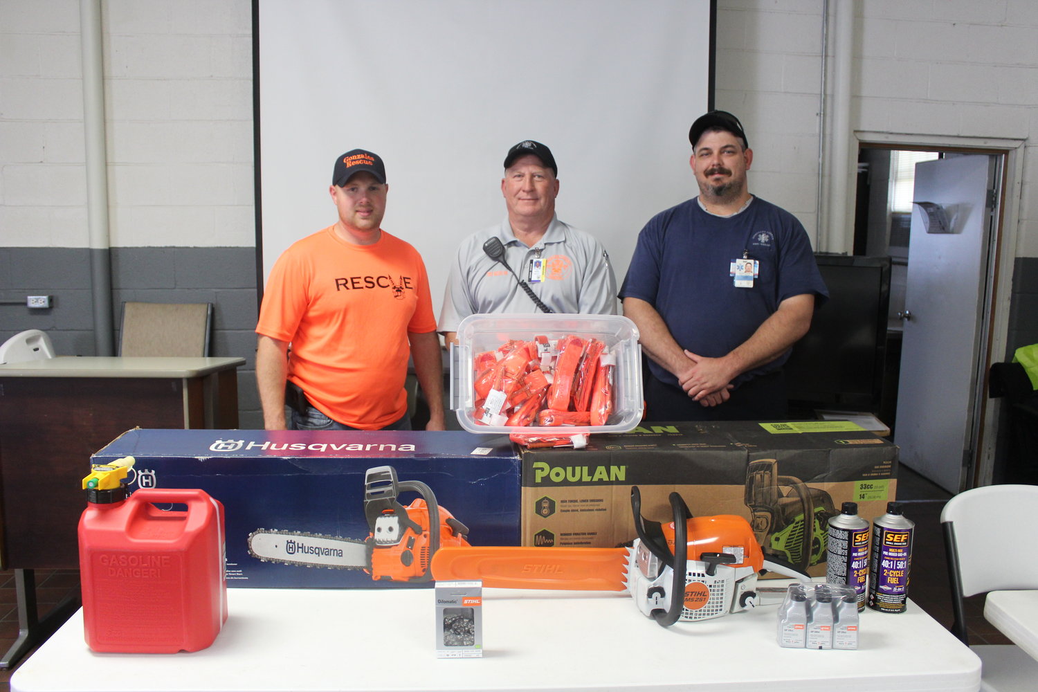 Tony Matias, Ken Colwell and James Cole of Gonzales County Rescue stand behind the new chain saws and tourniquets that were donated by area businesses to help support Rescue.